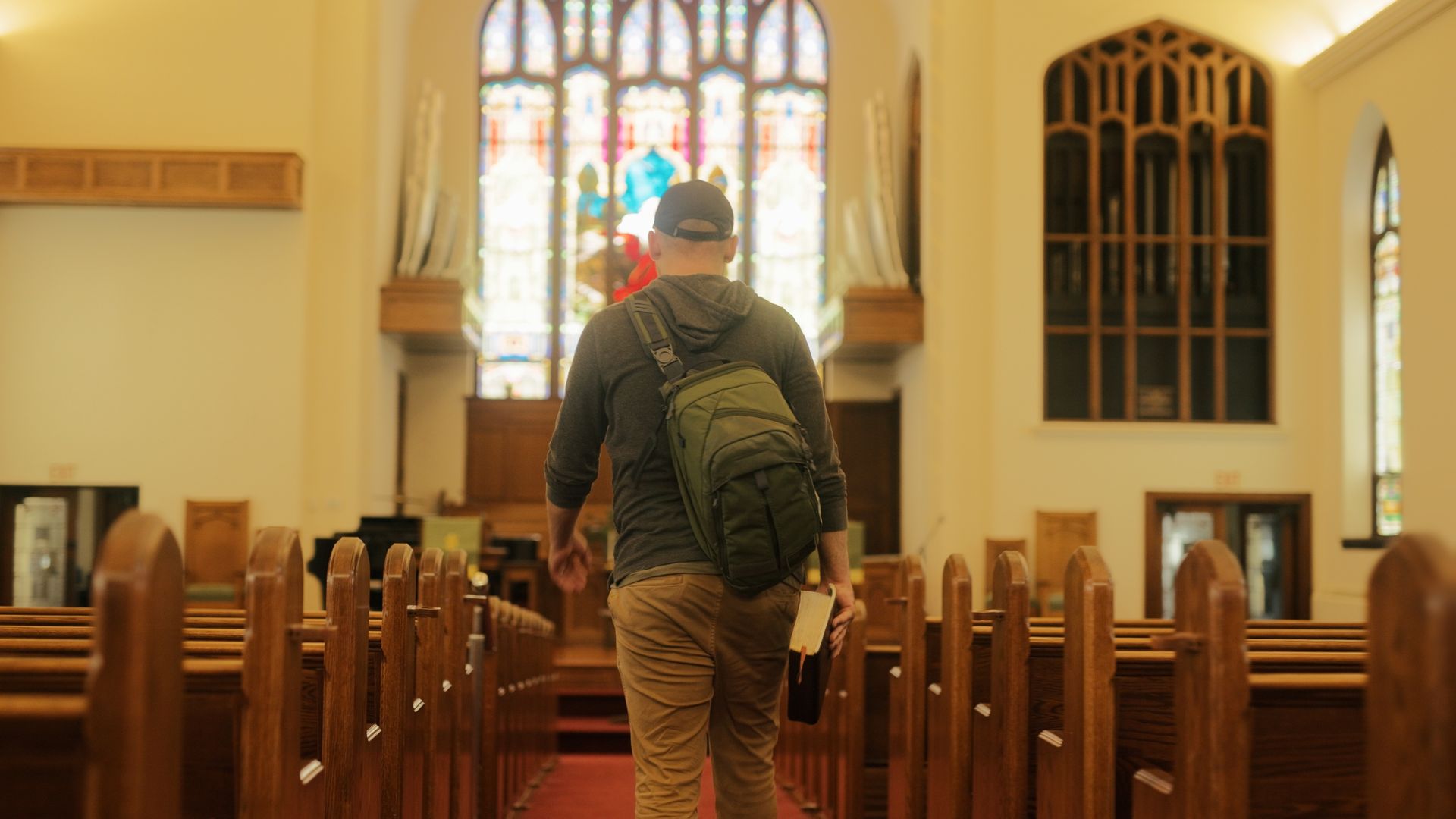 Jared walking into the church with bible in hand