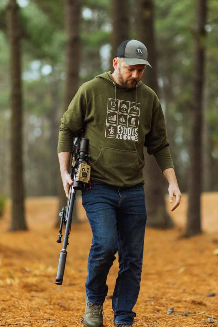 Jared walking through the woods with his Henry rifle