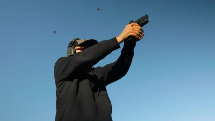 Firing a Pistol with a red dot mount
