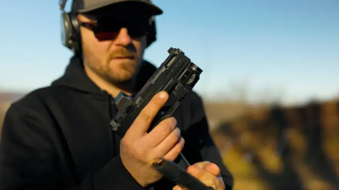Loading a pistol at the range Loading a pistol at the range